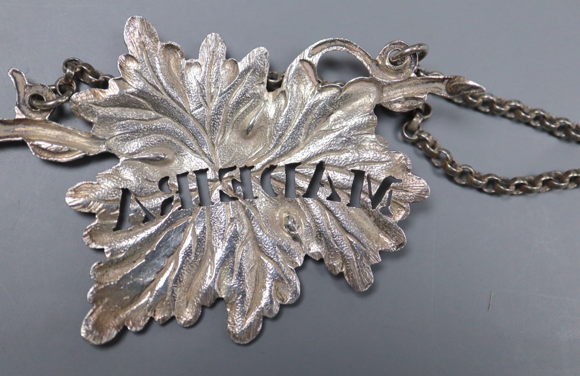 A set of three Victorian silver leaf wine labels, Yapp & Woodward, Birmingham, 1846, 7cm and one other pair.
